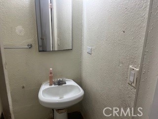 1020 West 24th Street Merced, CA 95340 - Photo 15 of 21 a bathroom with a sink and a mirror
