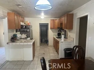 a kitchen with cabinets and chairs