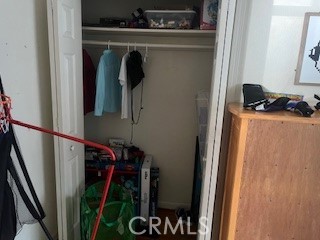 1020 West 24th Street Merced, CA 95340 - Photo 10 of 21 a view of walk in closet with clothes and shoes