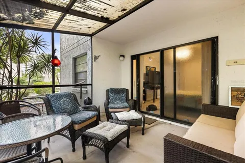 a living room with furniture and a floor to ceiling window