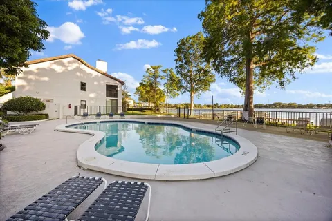 a view of swimming pool with outdoor seating and plants