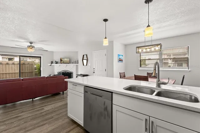 a kitchen with sink cabinets and wooden floor