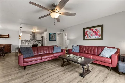 a living room with furniture a couch and chandelier