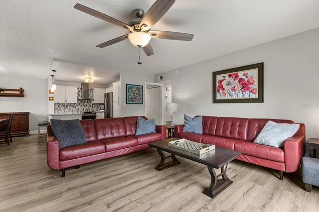 a living room with furniture a couch and chandelier
