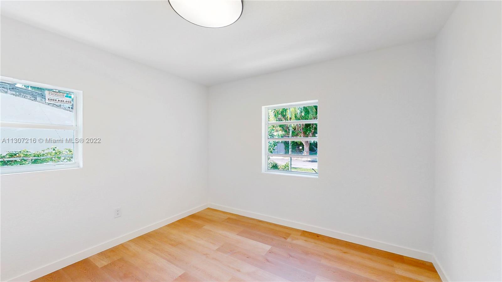 241 Southwest 31st Road Miami, FL 33129 - Photo 13 of 18 a view of a room with wooden floor and a window