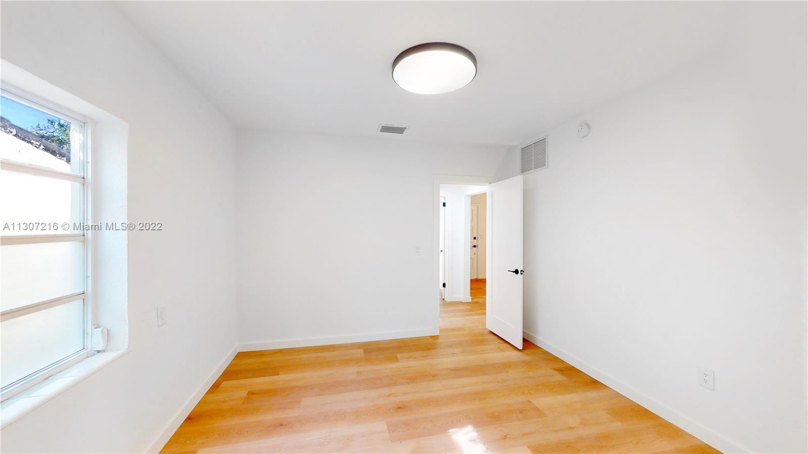 241 Southwest 31st Road Miami, FL 33129 - Photo 15 of 18 a view of a room with wooden floor and a window