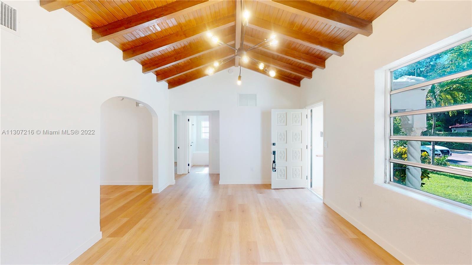 241 Southwest 31st Road Miami, FL 33129 - Photo 3 of 18 a view of a big room with wooden floor and windows