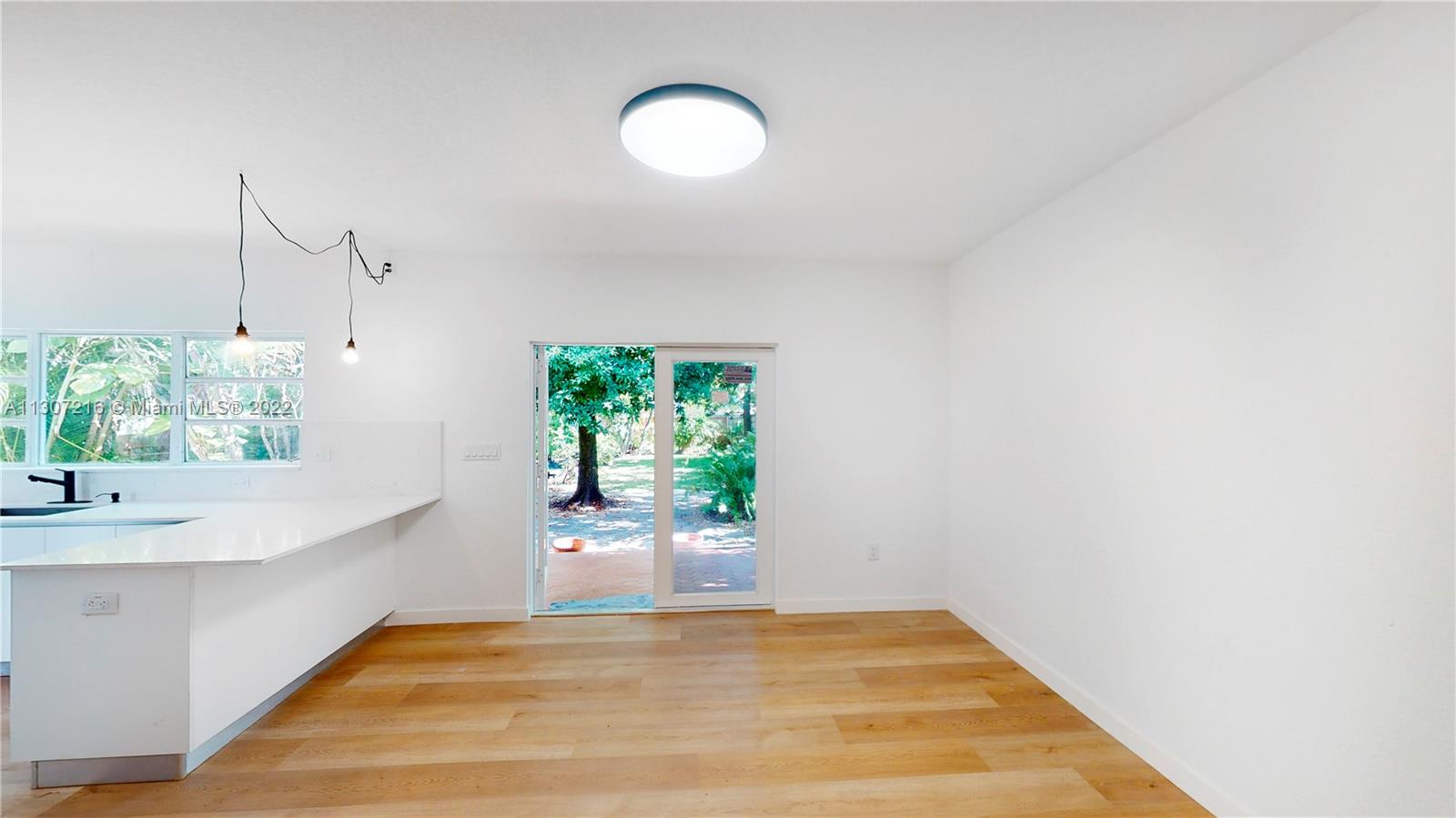 241 Southwest 31st Road Miami, FL 33129 - Photo 10 of 18 a view of a room with wooden floor and a window