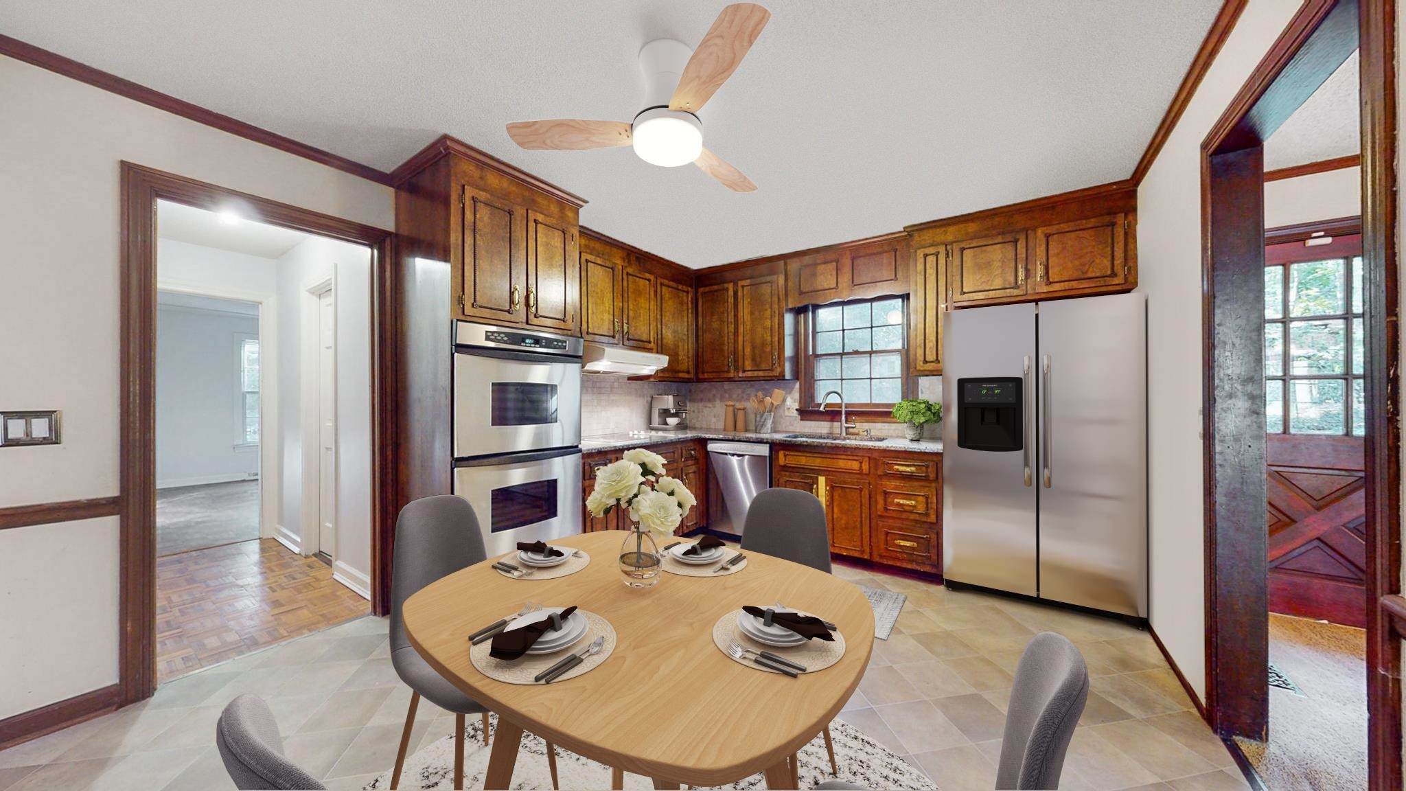 6909 Electra Drive Raleigh, NC 27607 - Photo 4 of 22 a open kitchen with stainless steel appliances granite countertop a stove a refrigerator a dining table and chairs with wooden floor