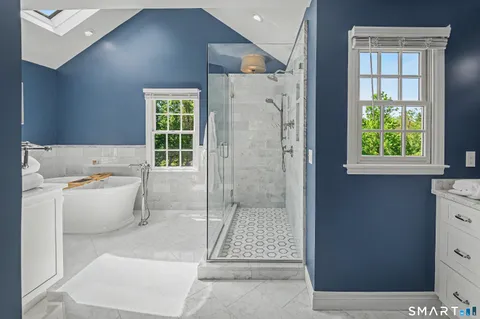 a bathroom with a tub shower and window