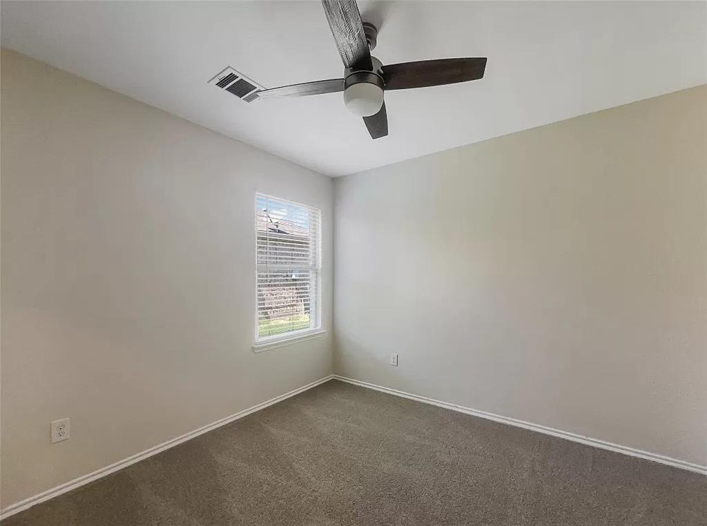 1809 Meadow Crest Drive Princeton, TX 75407 - Photo 12 of 20 an empty room with a window and a fan
