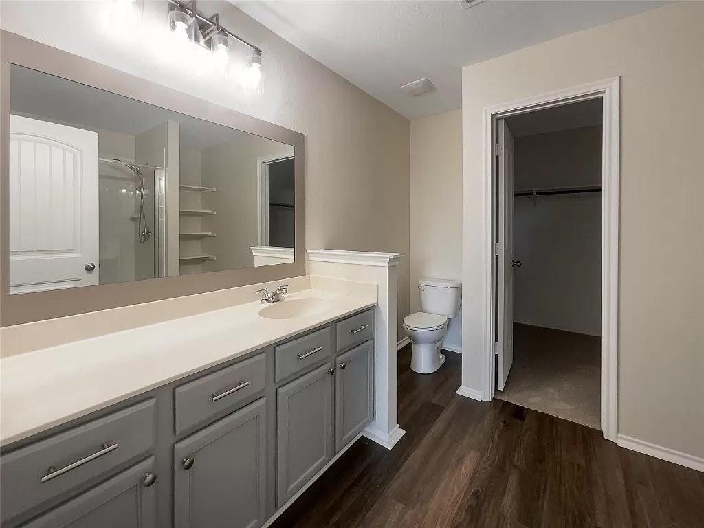 1809 Meadow Crest Drive Princeton, TX 75407 - Photo 18 of 20 a bathroom with a double vanity sink and a toilet