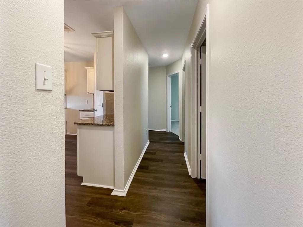 1809 Meadow Crest Drive Princeton, TX 75407 - Photo 9 of 20 a view of a hallway with wooden floor