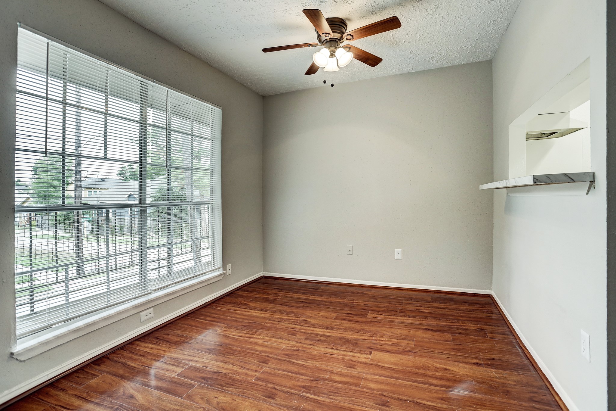 513 Ridge Street, Unit 21 Houston, TX 77009 - Photo 5 of 9 a view of empty room with wooden floor and fan