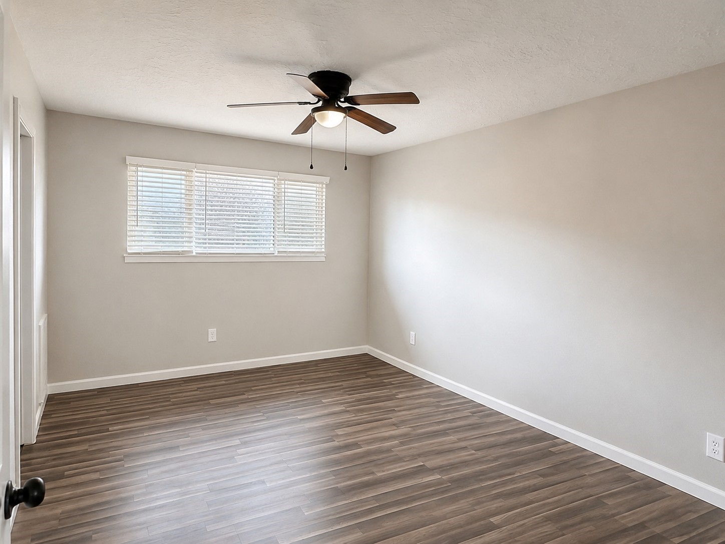 15950 Chimney Rock Road Missouri City, TX 77489 - Photo 5 of 9 a view of an empty room with wooden floor