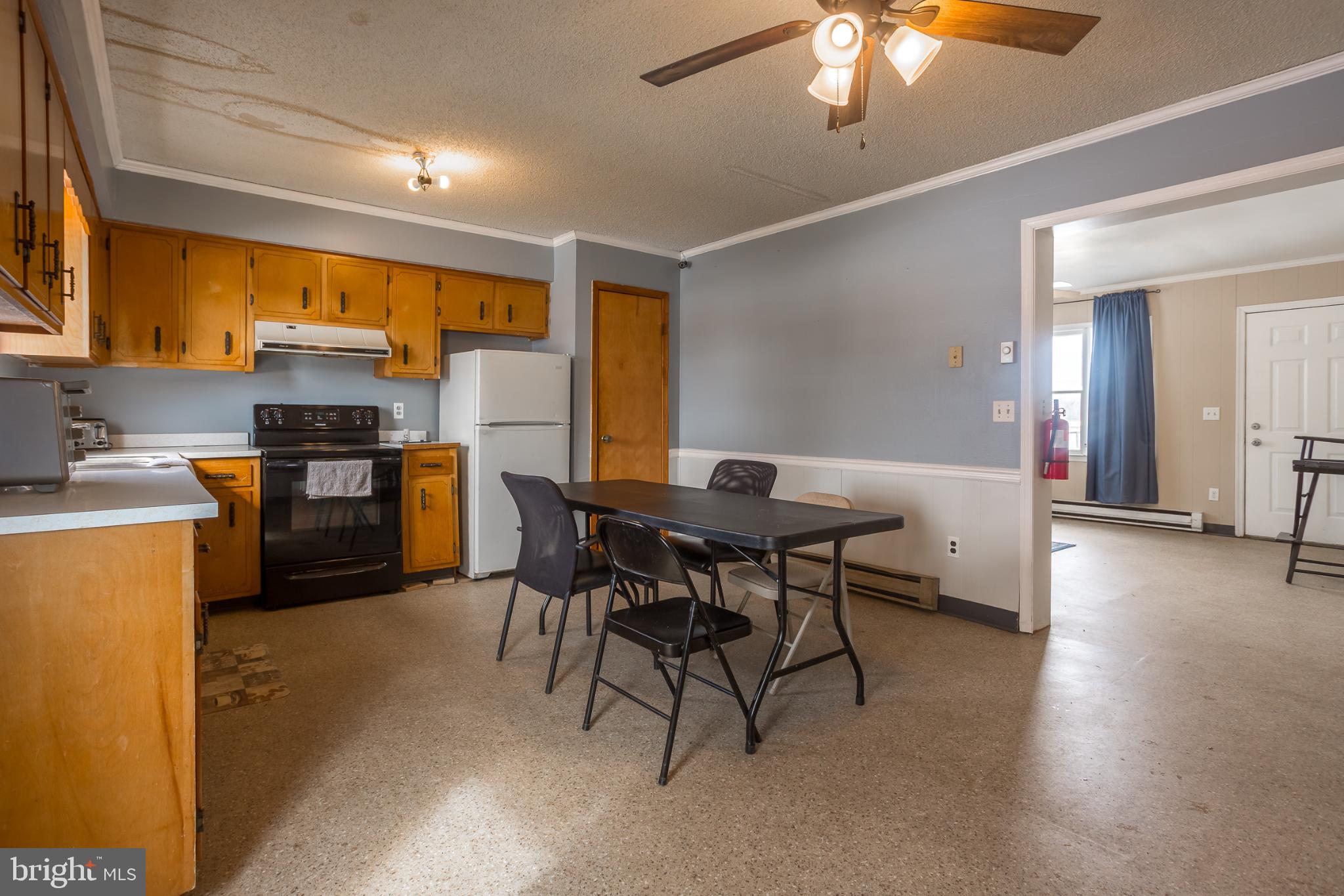 3985 White Road Federalsburg, MD 21632 - Photo 10 of 52 a kitchen with stainless steel appliances wooden floor dining table and chairs