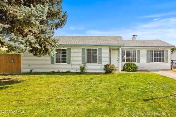 a house that has a big yard with wooden fence