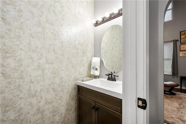 a bathroom with a sink vanity and a mirror
