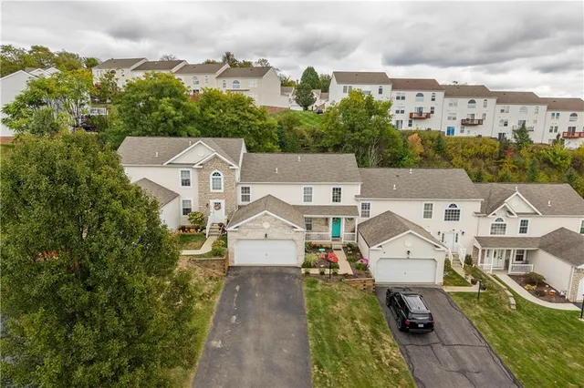 an aerial view of a house with swimming pool and mountains