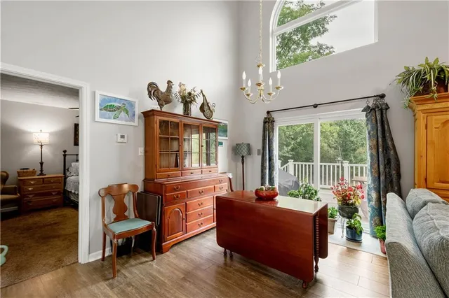 a living room with furniture fireplace and a large window