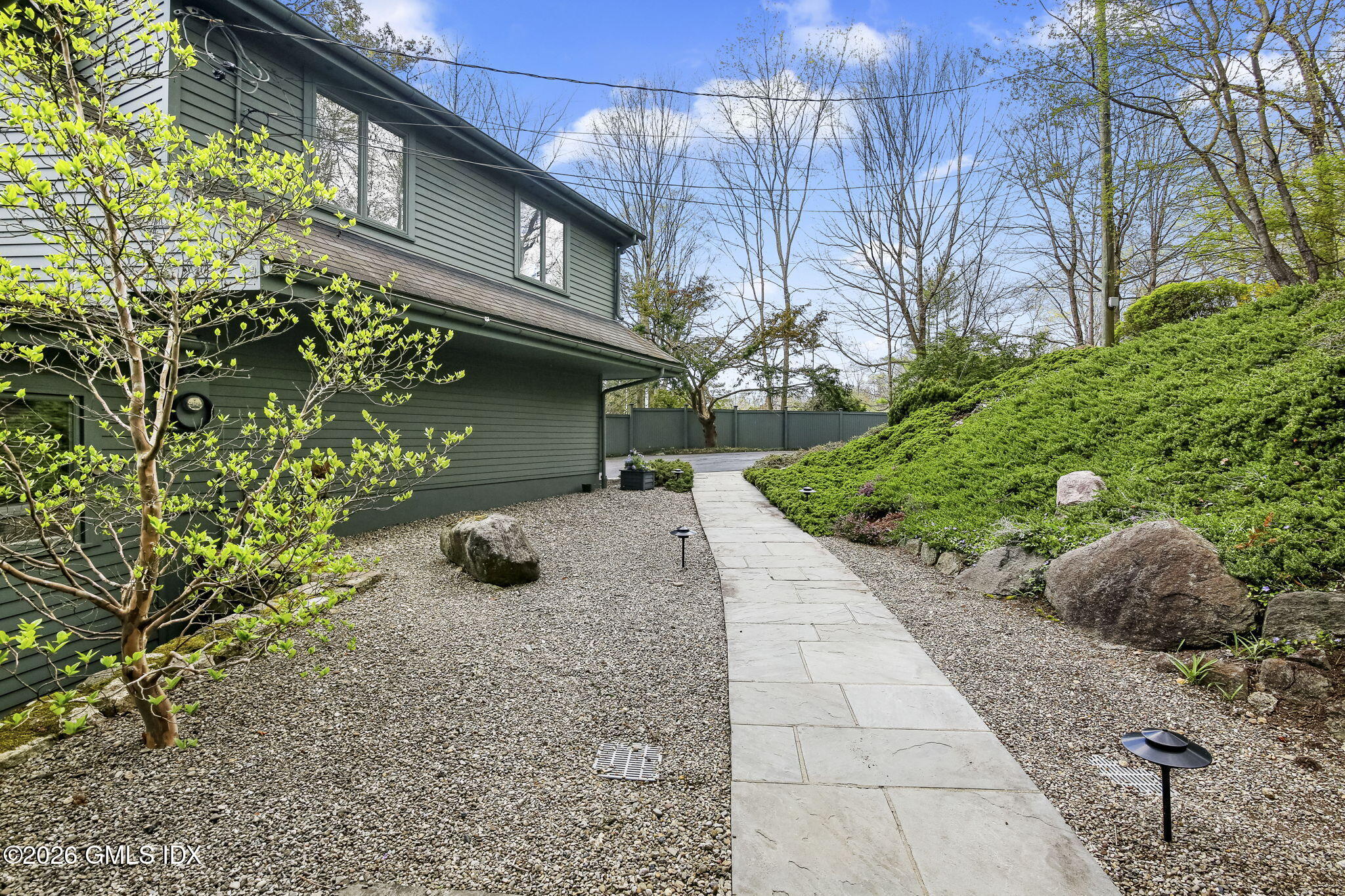 185 Valley Road Cos Cob, CT 06807 - Photo 3 of 38 a view of a street with plants and large trees