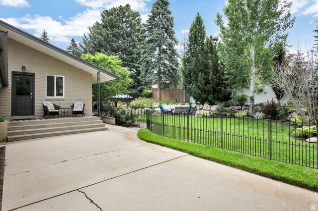 1350 Canyon Park Road Bountiful, UT 84010 - Photo 38 of 38 Rear exterior featuring a brick facade, covered patio, and concrete steps