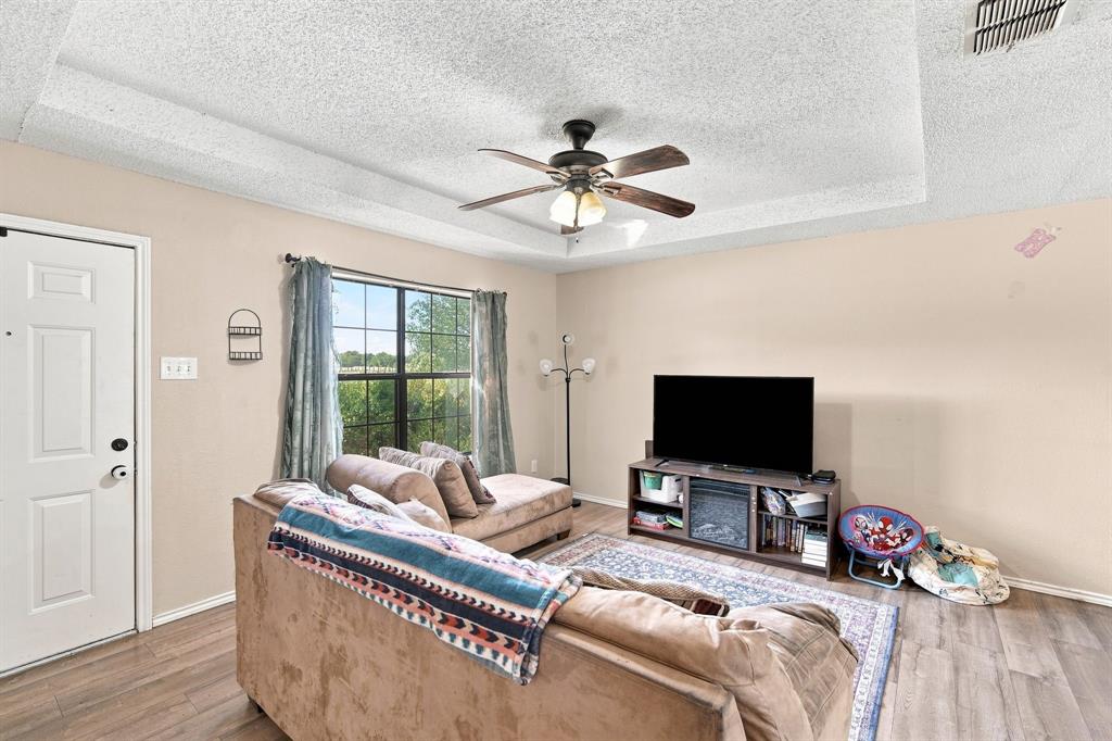 115 Solon Road Waxahachie, TX 75165 - Photo 3 of 13 Natural light and ceiling fan in living room