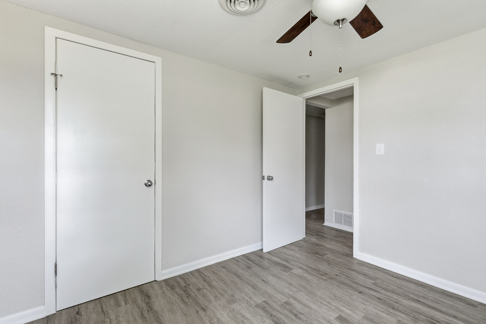 2306 9th Street Silvis, IL 61282 - Photo 23 of 32 an empty room with wooden floor and windows