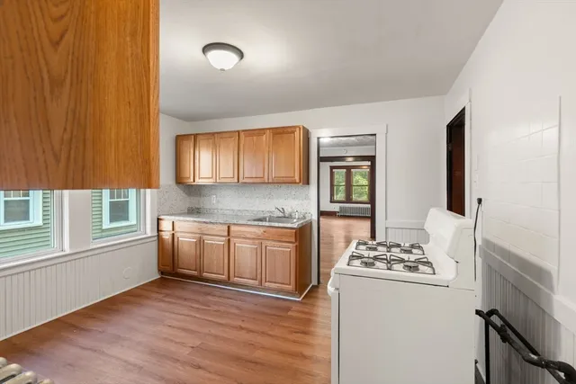 a kitchen with granite countertop cabinets stainless steel appliances a sink and a window