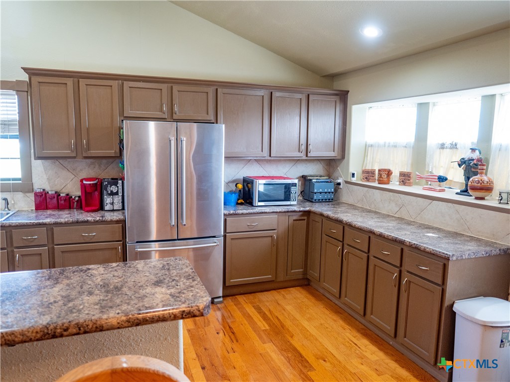1704 Jackson Street Port Lavaca, TX 77979 - Photo 13 of 40 a kitchen with stainless steel appliances granite countertop a refrigerator sink and cabinets
