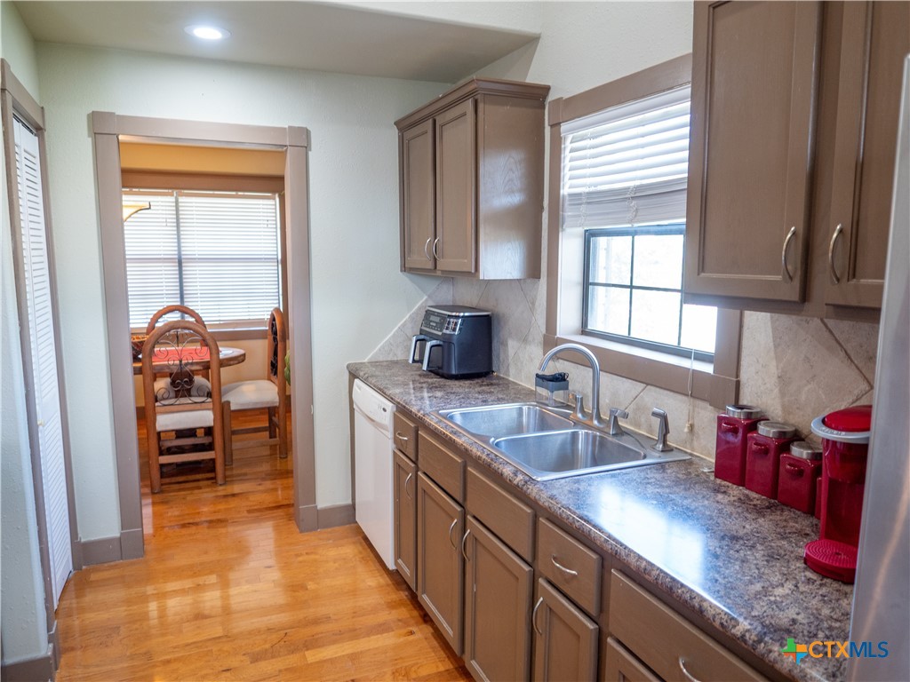 1704 Jackson Street Port Lavaca, TX 77979 - Photo 16 of 40 a kitchen with granite countertop a sink and a refrigerator