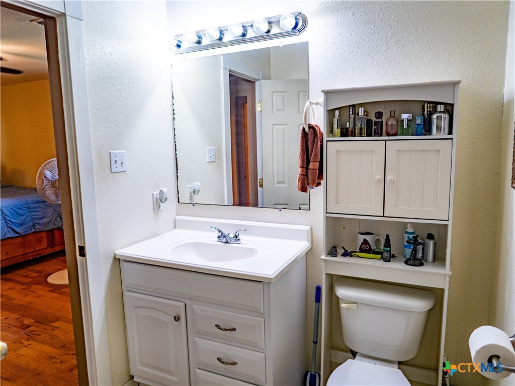1704 Jackson Street Port Lavaca, TX 77979 - Photo 32 of 40 a bathroom with a toilet sink and mirror