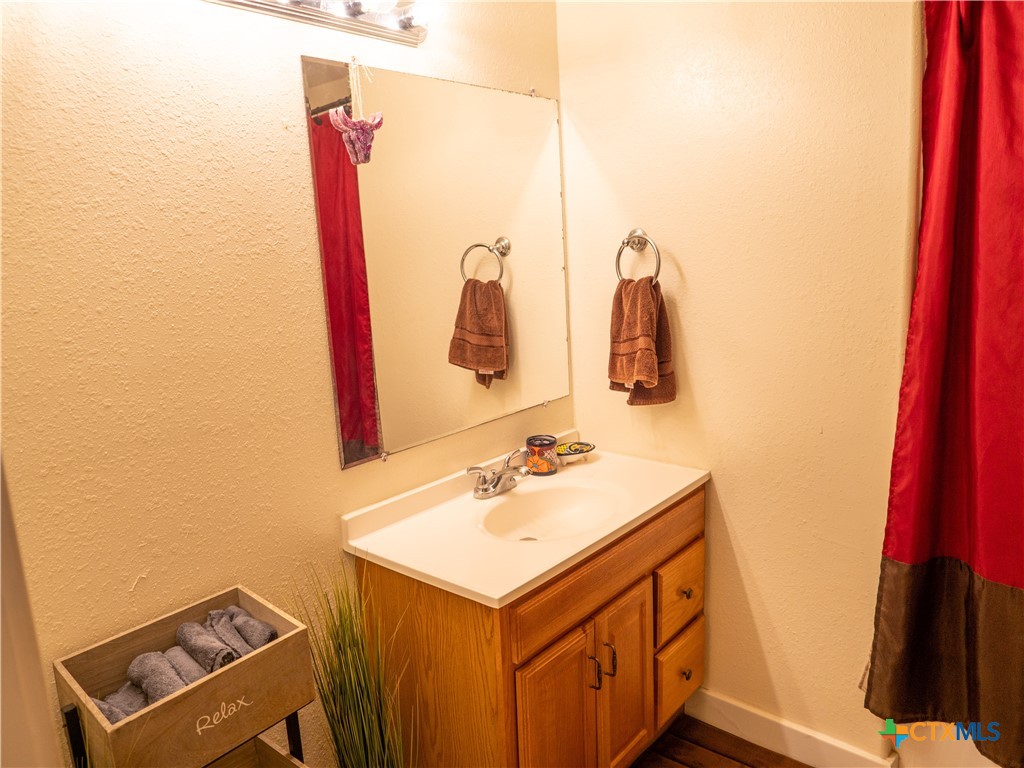 1704 Jackson Street Port Lavaca, TX 77979 - Photo 38 of 40 a bathroom with a sink and a mirror