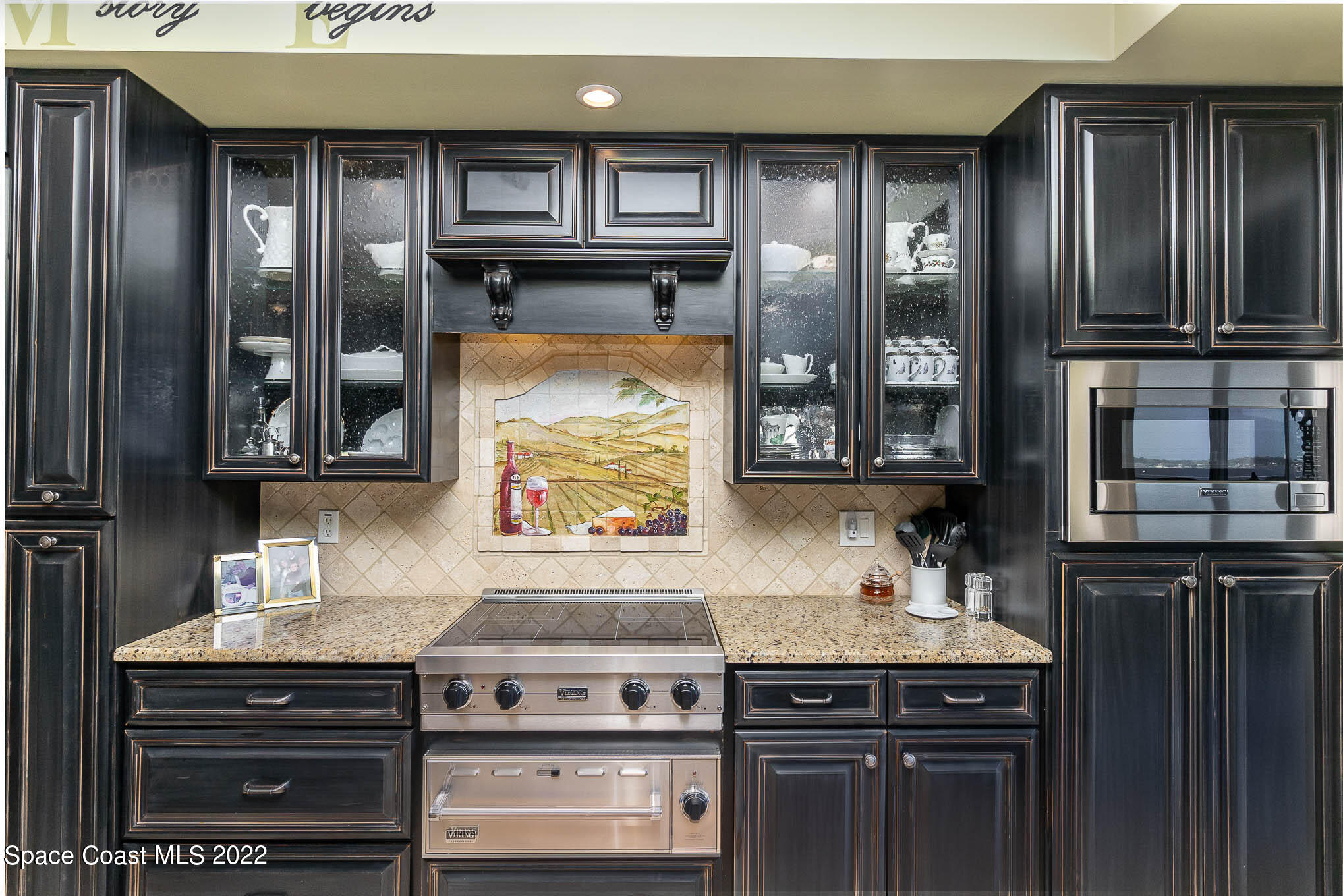 21 Riverside Drive, Unit 702 Cocoa, FL 32922 - Photo 16 of 53 a kitchen with stainless steel appliances granite countertop a stove and a microwave