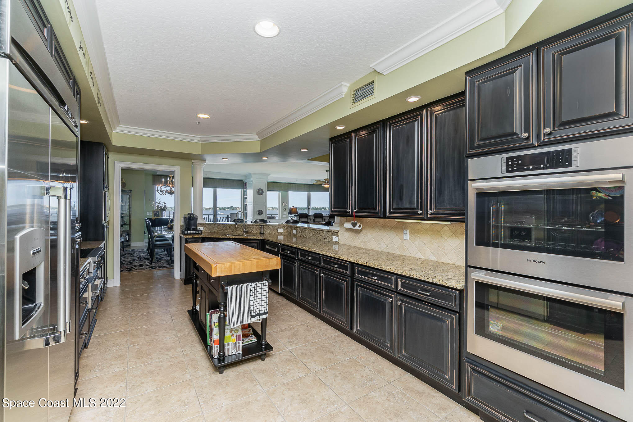 21 Riverside Drive, Unit 702 Cocoa, FL 32922 - Photo 17 of 53 a kitchen with sink refrigerator and stove