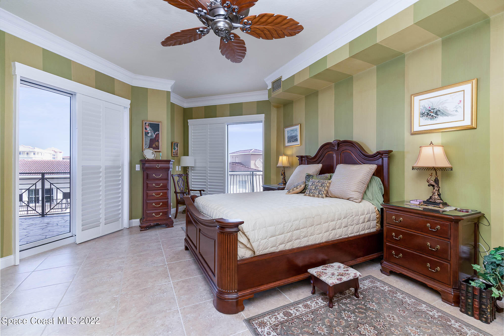21 Riverside Drive, Unit 702 Cocoa, FL 32922 - Photo 24 of 53 a spacious bedroom with a bed and a chandelier