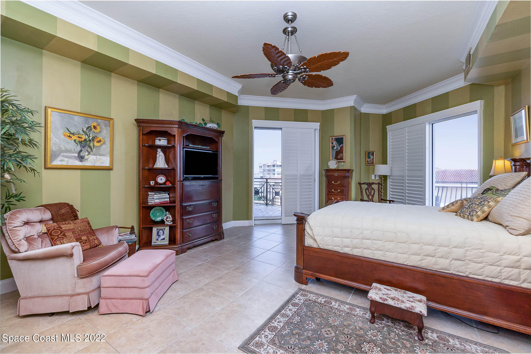 21 Riverside Drive, Unit 702 Cocoa, FL 32922 - Photo 26 of 53 a spacious bedroom with a bed and a television