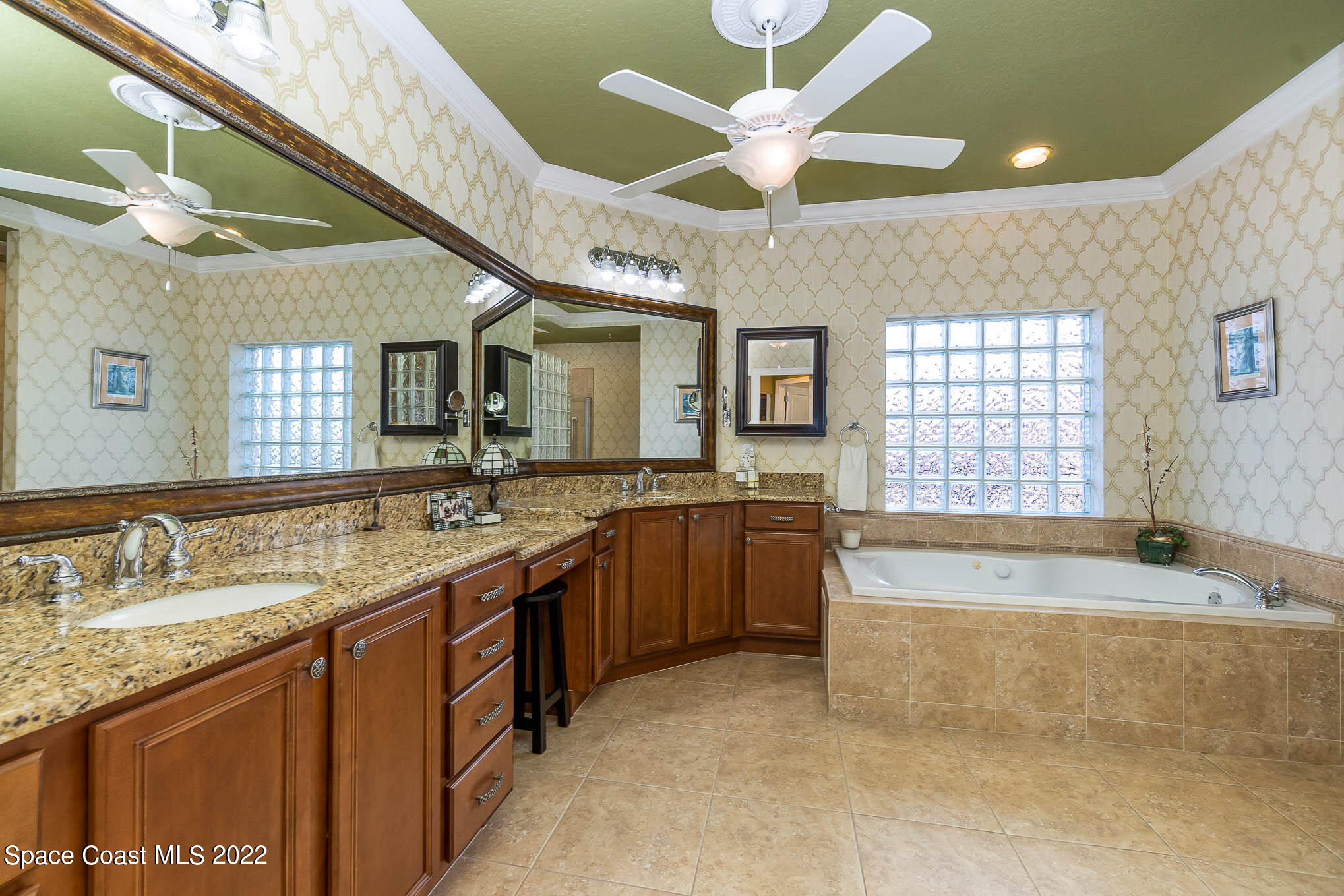 21 Riverside Drive, Unit 702 Cocoa, FL 32922 - Photo 28 of 53 a spacious bathroom with a granite countertop tub double vanity and a mirror