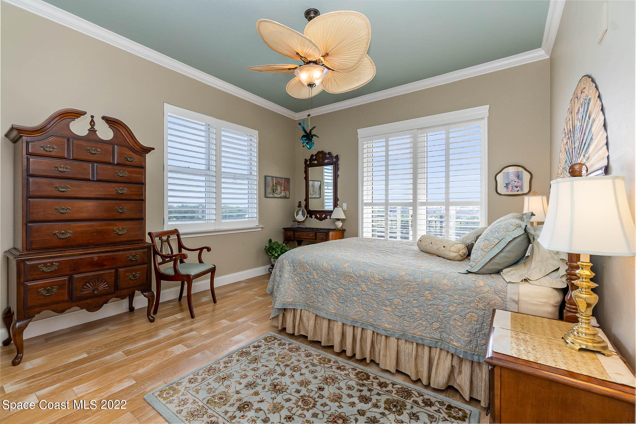 21 Riverside Drive, Unit 702 Cocoa, FL 32922 - Photo 29 of 53 a bedroom with a bed and wooden floor