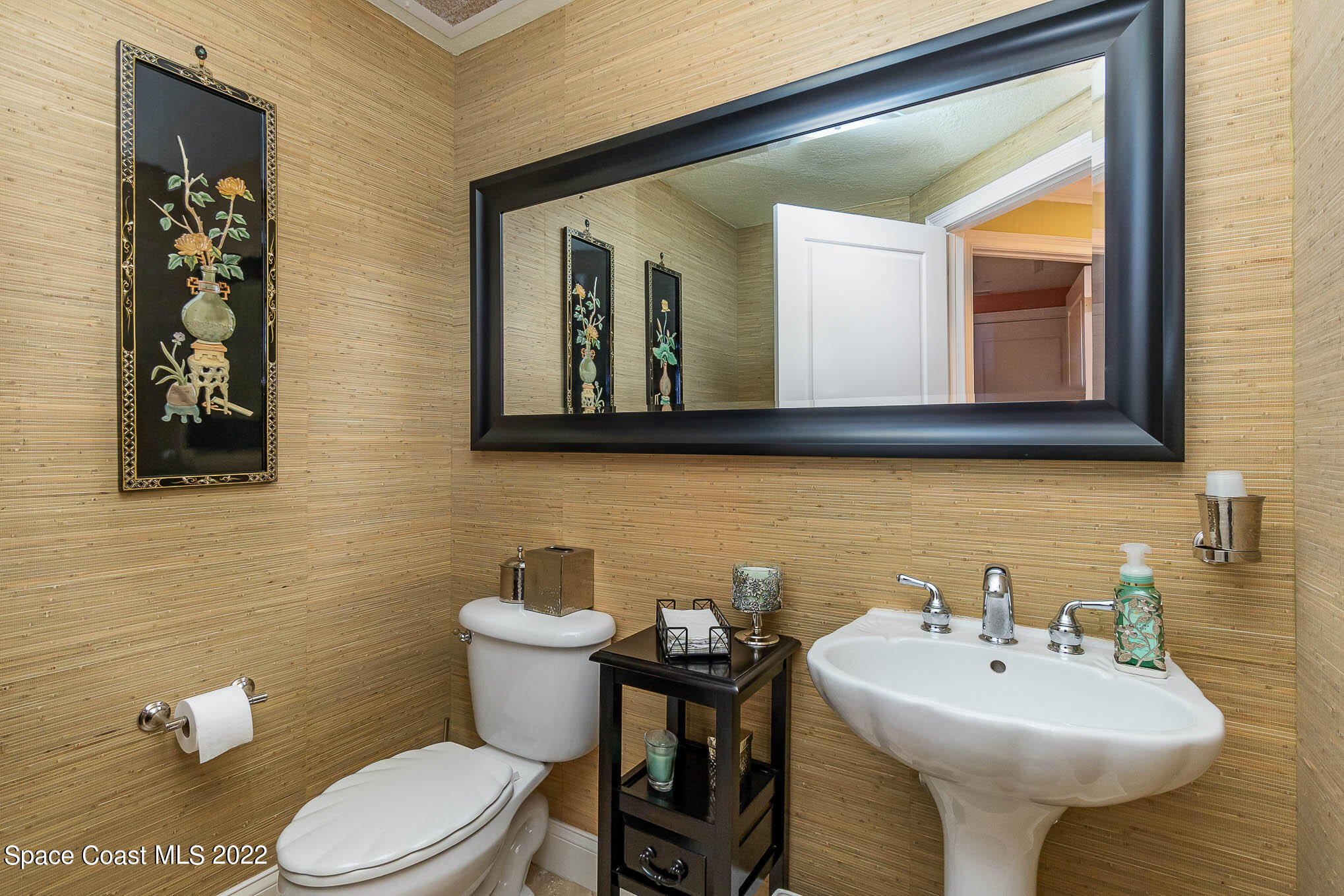 21 Riverside Drive, Unit 702 Cocoa, FL 32922 - Photo 32 of 53 a bathroom with a toilet sink and mirror