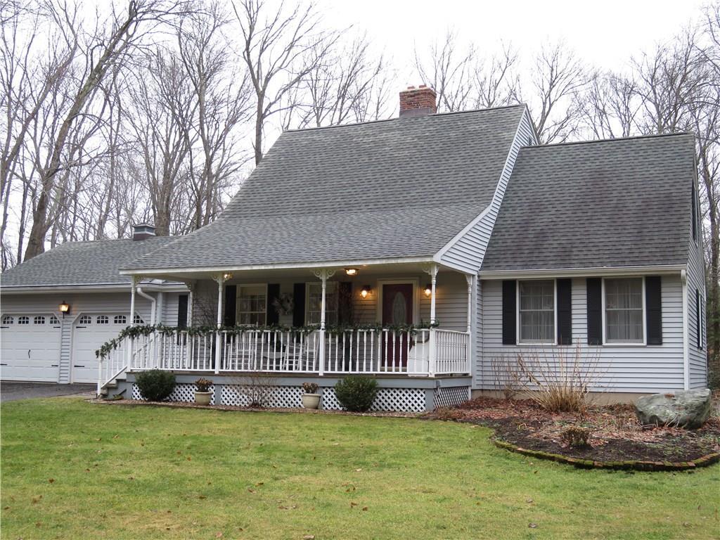 a view of a house with a big yard and a large tree
