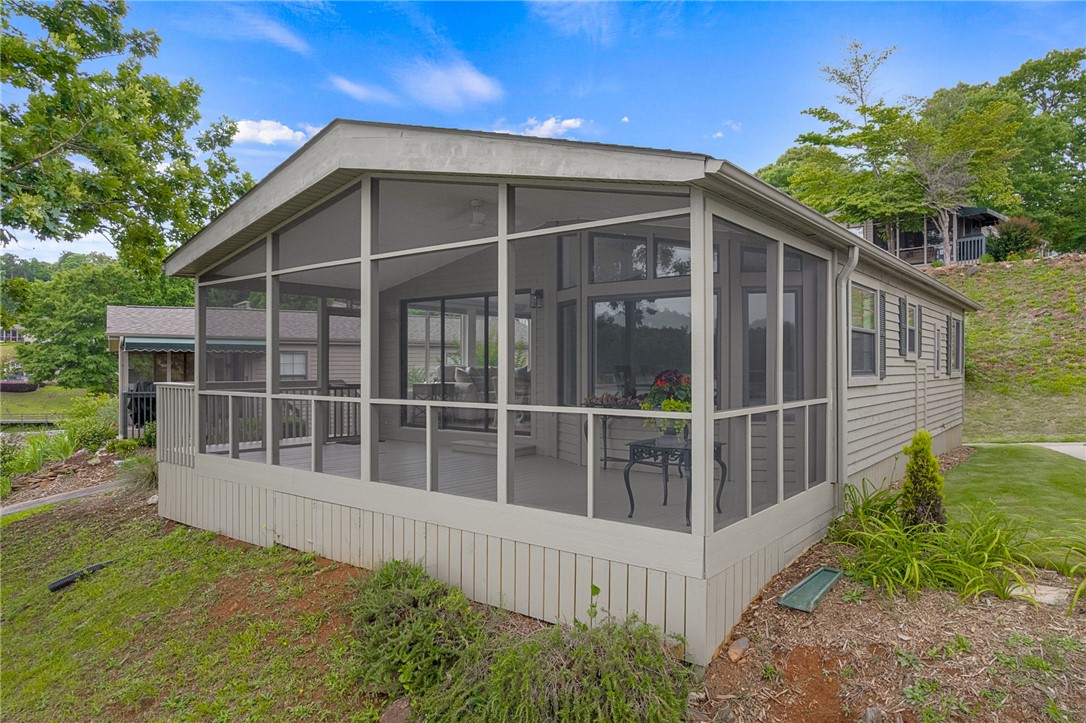 1230 Melton Road, Unit 30 West Union, SC 29696 - Photo 27 of 42 A lakeside screened porch offers tranquil outdoor living space and verdant views.
