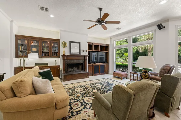 a living room with furniture a fireplace and a large window