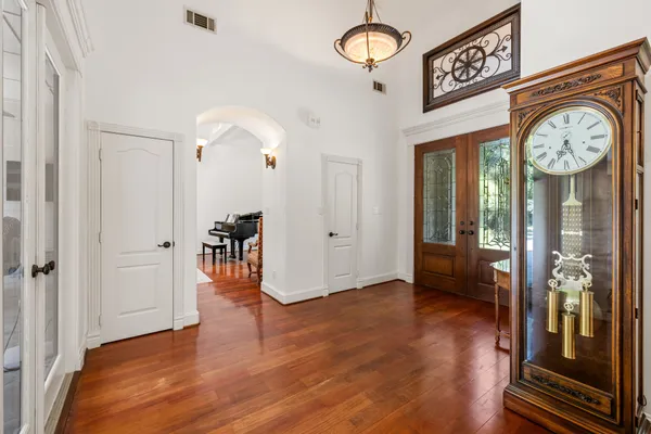 a view of a hallway with wooden floor