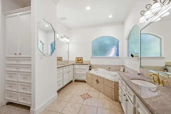a spacious bathroom with a granite countertop sink mirror and
