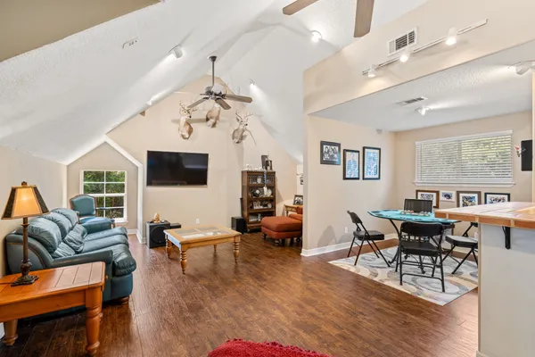 a living room with furniture and wooden floor