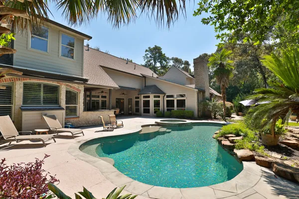 a view of a house with swimming pool and sitting area