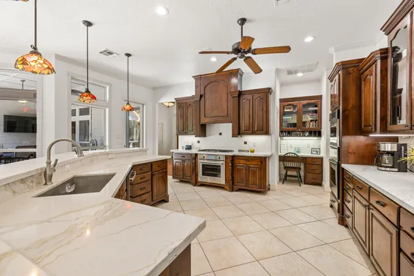 a kitchen with stainless steel appliances kitchen island granite countertop a sink and cabinets