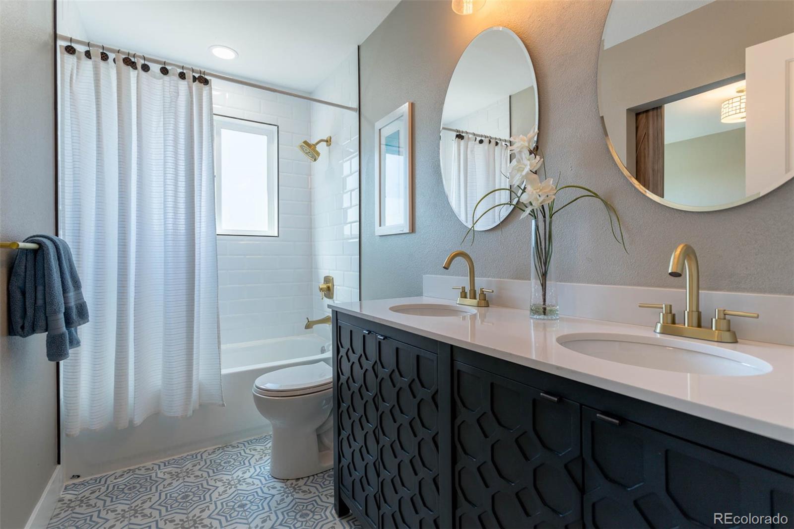 4465 South Eagle Circle Aurora, CO 80015 - Photo 15 of 26 a bathroom with a double vanity sink mirror and toilet
