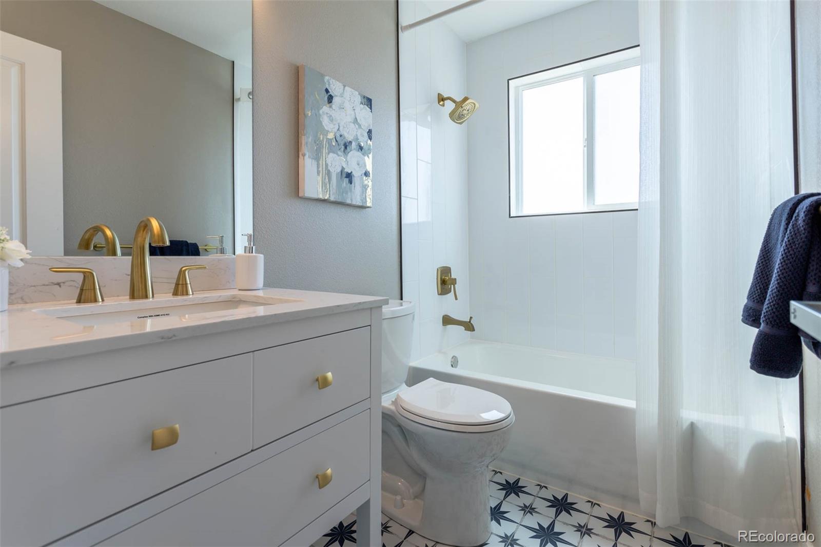 4465 South Eagle Circle Aurora, CO 80015 - Photo 18 of 26 a bathroom with a sink a toilet and shower
